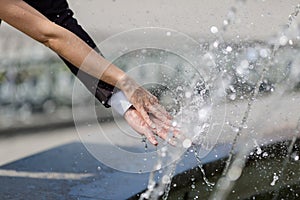 Hands of newly wedded under running water