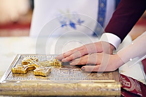 Hands of newlyweds on bible