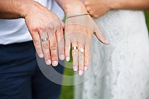 Hands newlyweds display their wedding rings