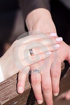 Hands of the newlyweds with rings