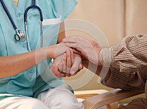 Hands of nurse and elderly patient. photo
