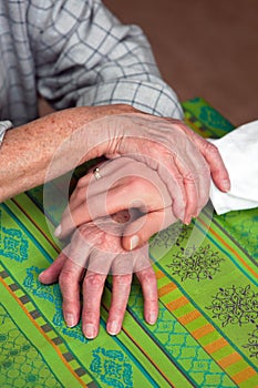 Hands of a nurse and a former senior