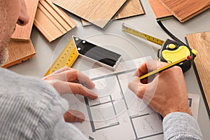 Hands in office developing interior project with wood detail