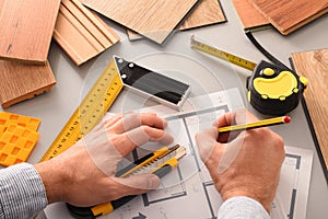 Hands in office developing interior project with wood elevated view