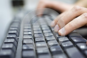 Hands of an office operator typing on dirty keyboard