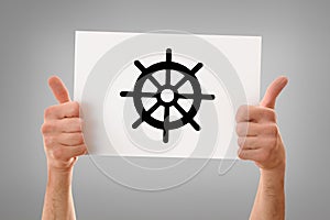 Hands okay holding a poster with dharma wheel isolated gray