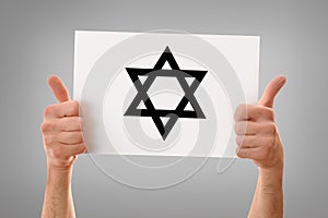 Hands with okay holding a poster with star gray isolated
