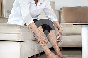 Hands of old elderly scratching legs,itching from mosquitoes,insect bites allergy or dry itchy skin, senior woman suffers from