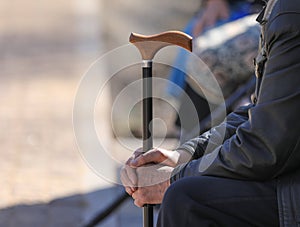 hands of an old man with crutch outdoors