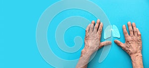 hands old man symbol lungs on blue background, banner, copyspace. healthy lungs, allergies and asthma, lung cancer.