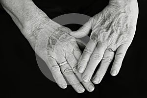 The hands of an old woman in black and white