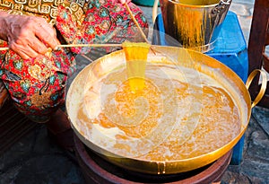 Hands of old women making foi thong dessert