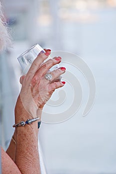 Hands of Older Woman Holding Drink photo