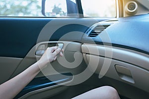 Hands open door car and lock door control panel of auto button glass controlling window in the car