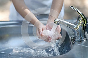 Hands open for drinking tap water. Pouring fresh drink. Good habit. Right choice. Child washes his hands. Healthy lifestyle. Water