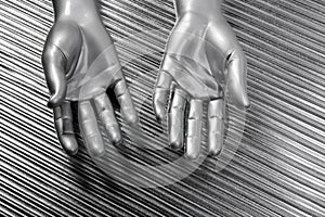 Hands open futuristic robot silver steel over gray