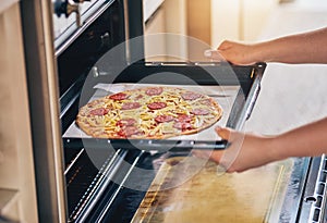 Hands, open oven and cooking pizza for food, restaurant or fast food with skill in home kitchen for baker in Naples