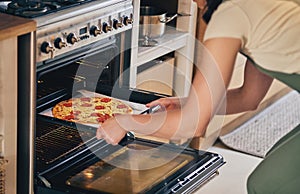 Hands, open oven and pizza baker for food, restaurant and fast food with skill in home kitchen for baker in Naples. Chef
