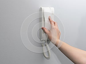 Hands opening door through intercom