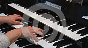 Hands on an organ keyboard