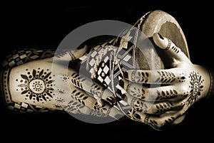 Hands with oriental tattoo and drum photo