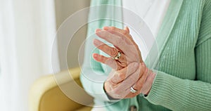 Hands, pain and arthritis with a senior woman in her nursing home, struggling with a medical injury or problem