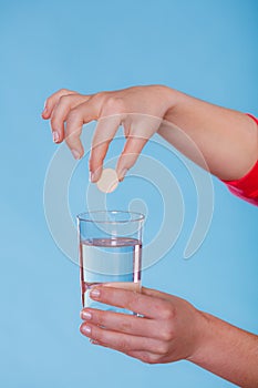 Hands with painkiller pill and water. Health care.