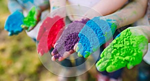 Hands Palms of young people covered in purple, yellow, red, blue Holi festival colors isolated