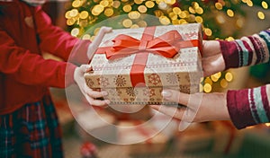 Hands of parent giving a x-mas gift to child