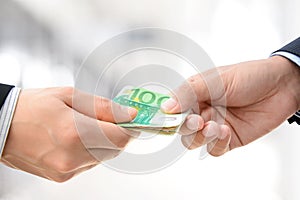 Hands passing money - Euro (EUR) bills photo