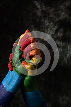 Hands patterned with the rainbow flag