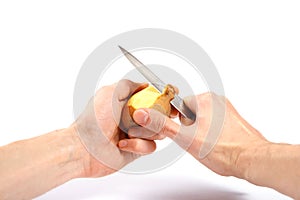 hands peel potato with knife