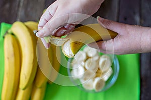 Hands peeling a banana for breakfast photo