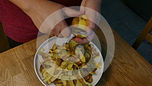 Hands peeling potatoes with peeler