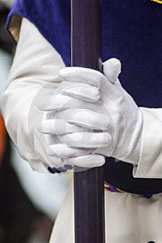 Hands of a penitent holding a candle