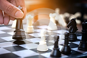 The hands of the people on the competition and the strategic planning guidelines on the checkmate board. Succeed