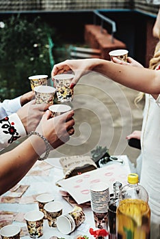 Hands of people with cups of alcohol, celebrating and toasting, wedding or birthday event