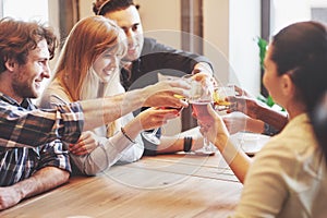 Hands of people with glasses of whiskey or wine, celebrating and toasting in honor of the wedding or other celebration