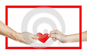 The hands of people hold a red heart in a red frame. Valentines day relationship concept. On isolated background