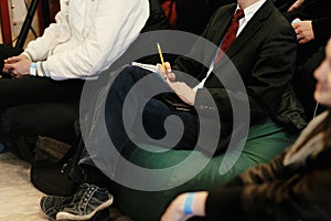 hands of people holding notes and learning and writing at business meeting, audience marketing lecture coaching