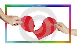 Hands of people tearing the heart apart in a multi-colored frame. Valentine`s day concept. Torn heart. On background