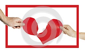 The hands of people tearing the heart apart in a red frame. Valentine`s day concept. Torn heart. On isolated background