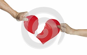 The hands of people tearing the heart apart. Valentine`s day concept. Torn heart. On isolated background