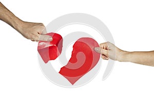 The hands of people tearing the heart apart. Valentine`s day concept. Torn heart. On isolated background