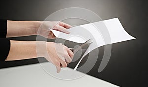 Hands of person cutting paper