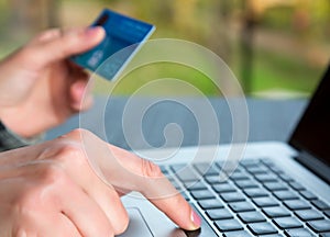 Hands of person entering credit Card Data on Laptop