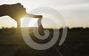 Hands of person making frame distance or symbol in nature