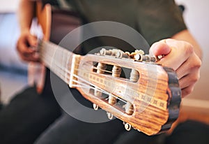 Hands, person and tuning guitar for music, talent and creative skill in sound production. Closeup, musician and singer