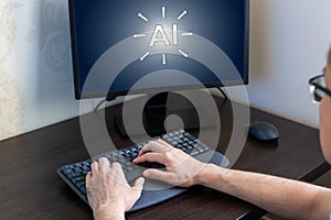 Hands of person typing on keyboard in front of computer screen displaying AI concept