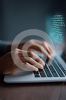 Hands of a person typing on a laptop keyboard, with binary code overlay, representing digital technology, coding, and data